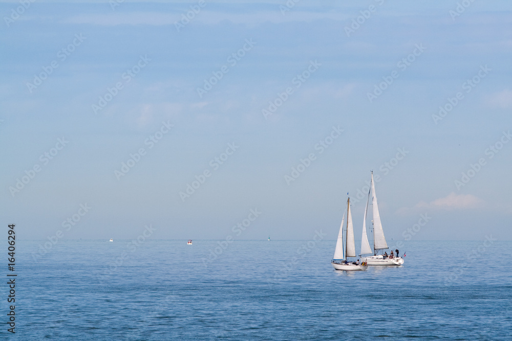 A pair of sailboats in the sea