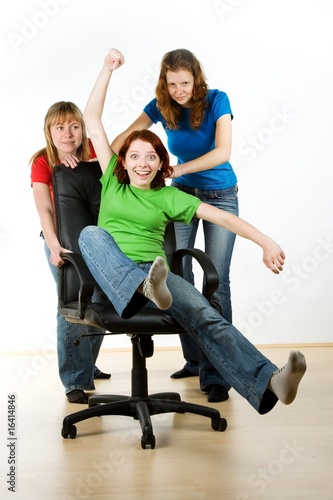 Women playing on office chair photo