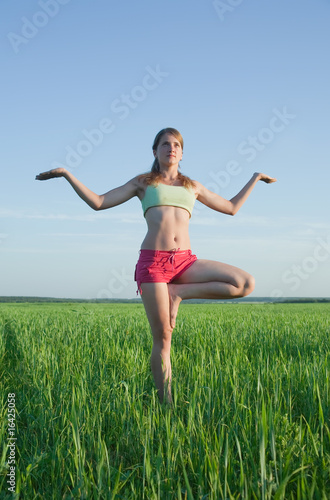 Young girl doing yoga against nature