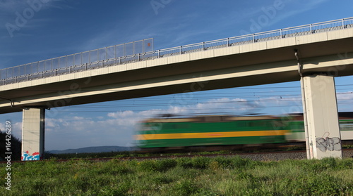 Fast train passing under a bridge