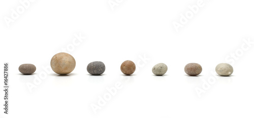 row of seven pebbles, one larger than the others