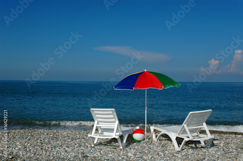 Chaise lounges and umbrella on a beach
