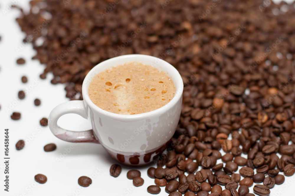 Coffee cup with beans over white background. Coffee cup with beans over white background.