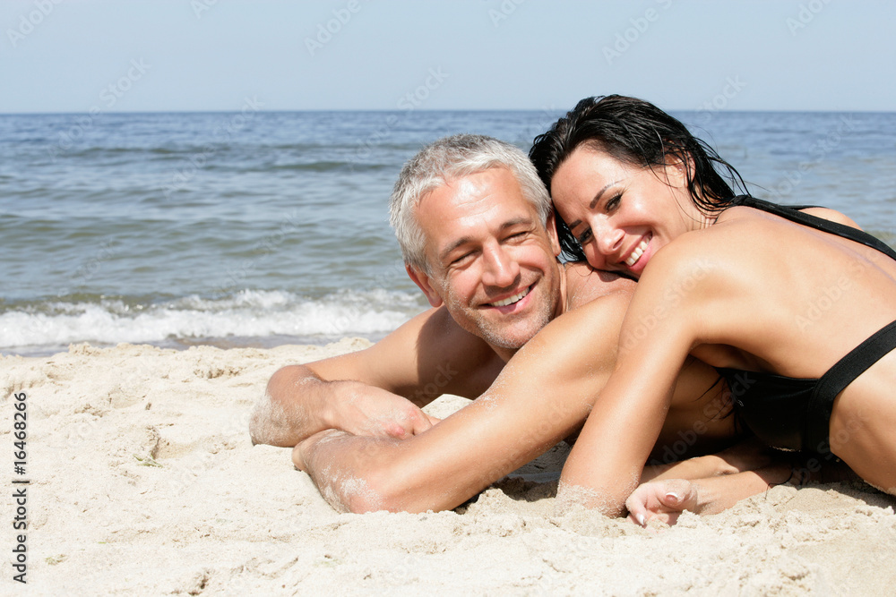 Attractive mature couple relaxing on the beach Attractive mature couple relaxing on the beach