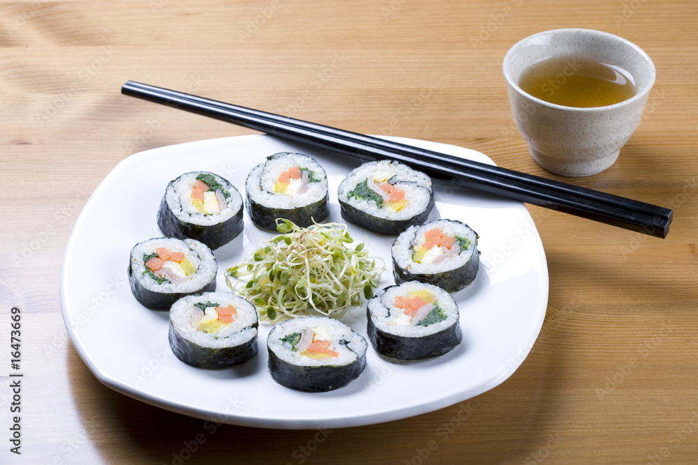 Cup of tea and Korean sushi called Kimbap. Cup of tea and Korean sushi called Kimbap.
