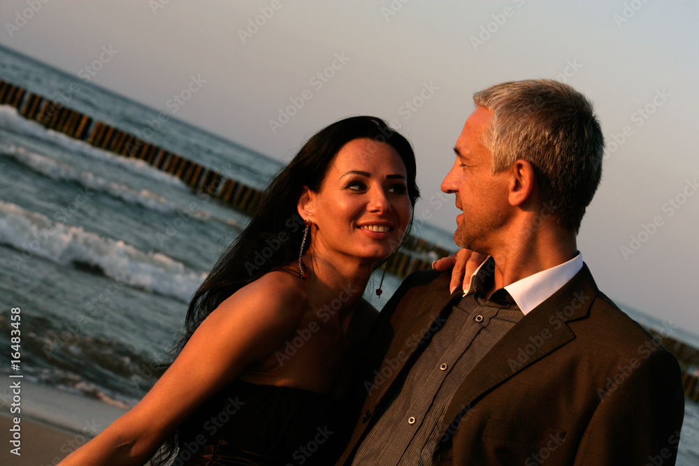 Attractive mature couple and romantic sunset on the beach Attractive mature couple and romantic sunset on the beach