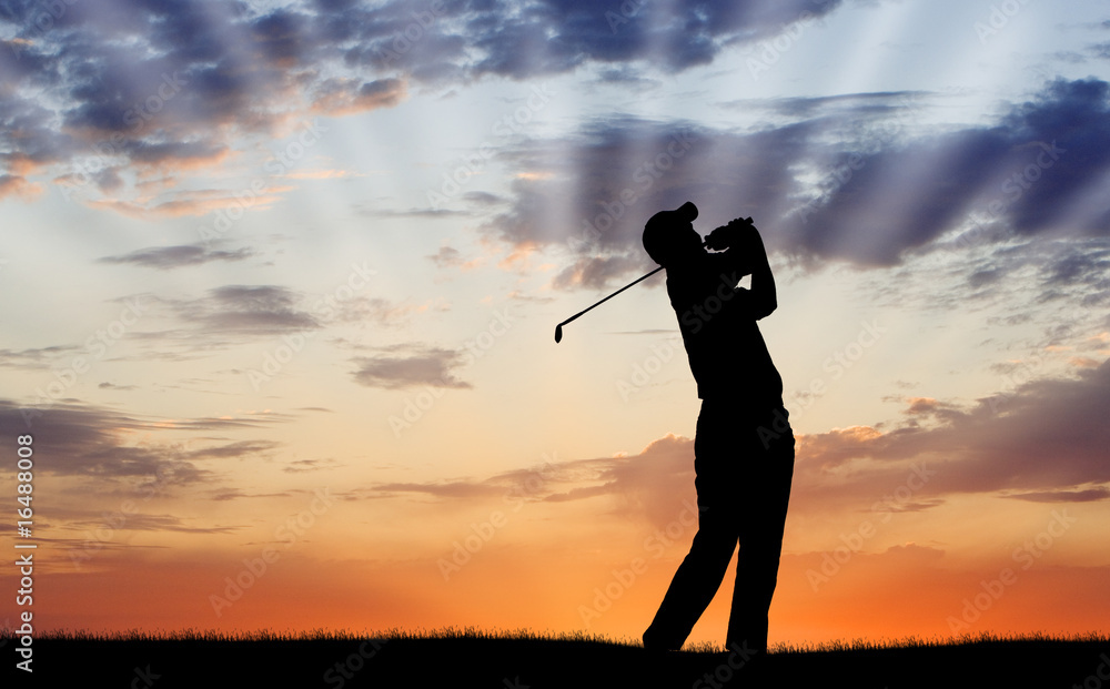 Golfer silhouetted against beautiful sunrise
