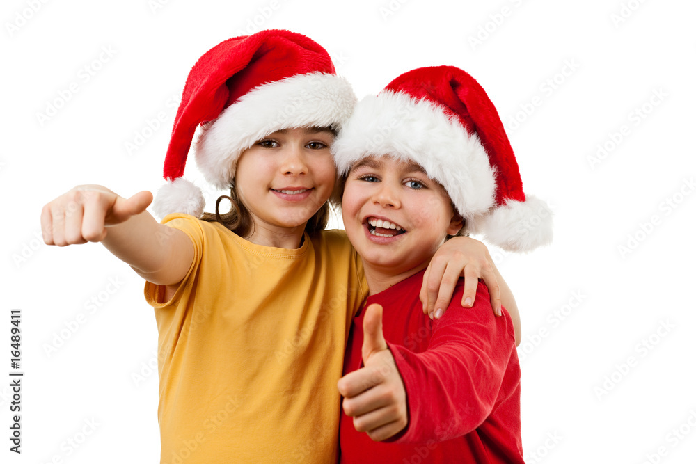 Kids wearing Santa Claus hats showing OK sign , isolated Kids wearing Santa Claus hats showing OK sign , isolated