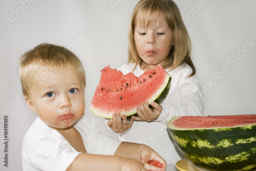 Two children eat Watermelon photo