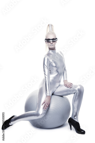 Beautiful cyber woman sitting on a silver ball ....