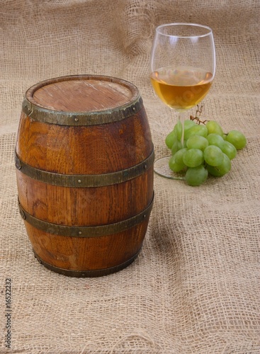 old barrel with glass of wine and grapes