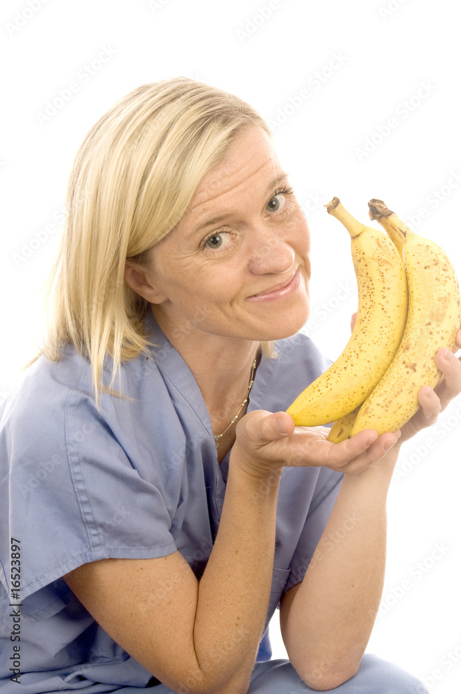 smiling happy nurse doctor with healthy fresh bunch ripe bananas smiling happy nurse doctor with healthy fresh bunch ripe bananas