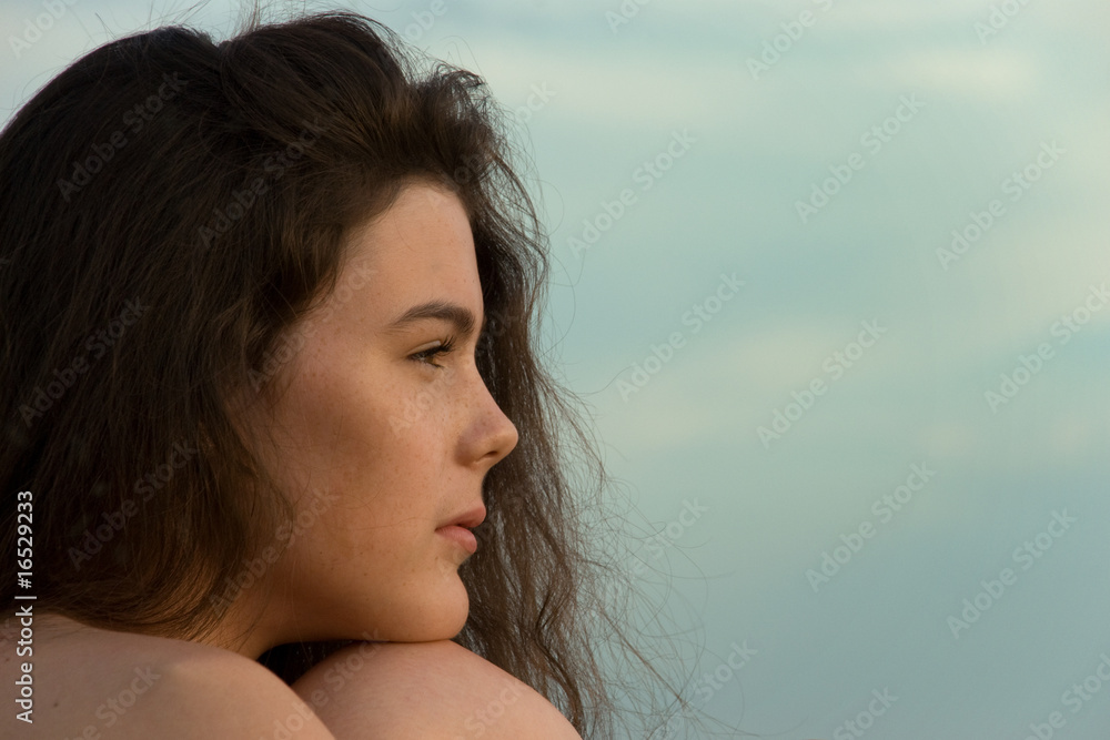 Dreamy curly girl against the green. sky. Dreamy curly girl against the green. sky.