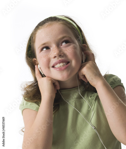 Young girl smiling listening to earphones on white background photo