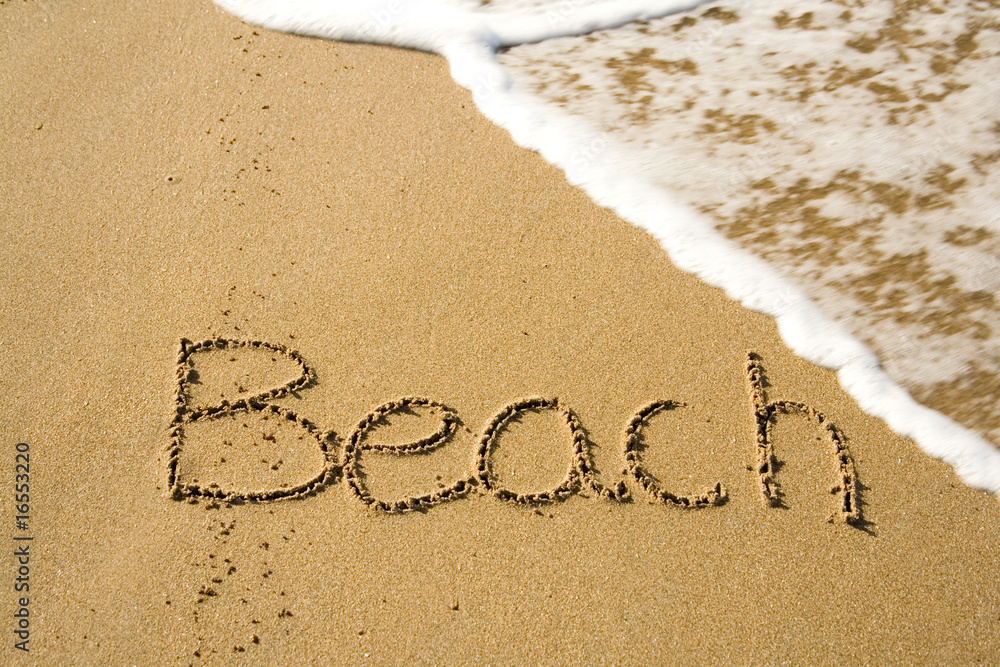 Fototapeta premium Word Beach written on the sand
