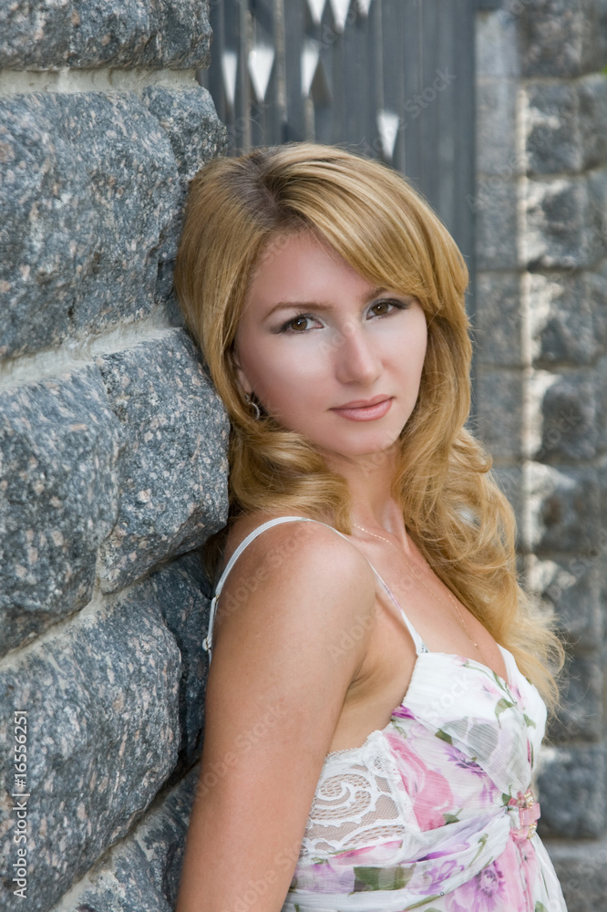 Portrait of girl on a background a stone wall