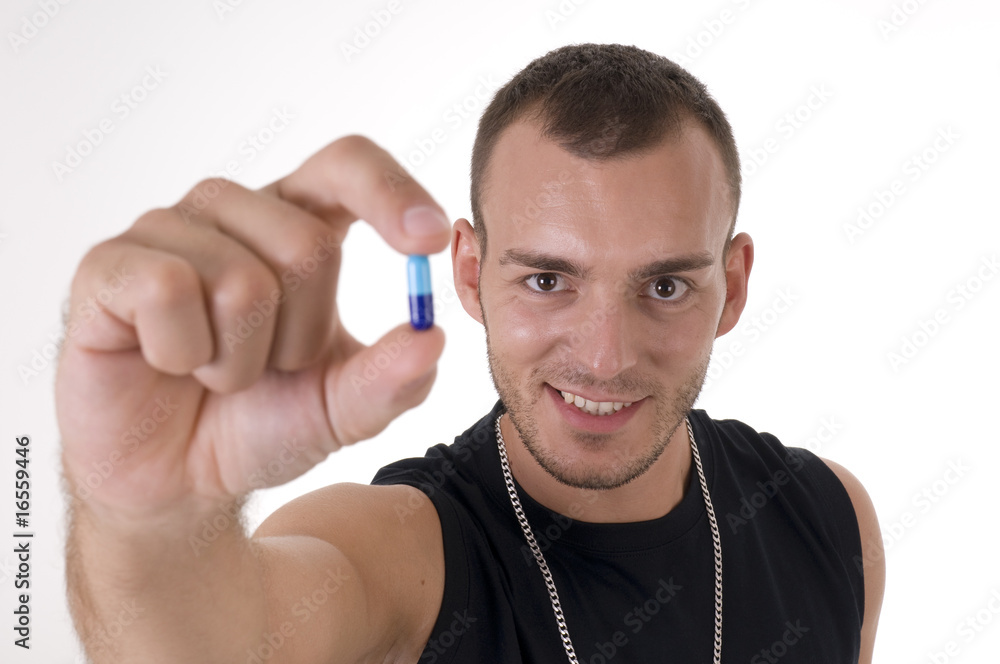 Young caucasian smiling man with pill focus on face Young caucasian smiling man with pill focus on face