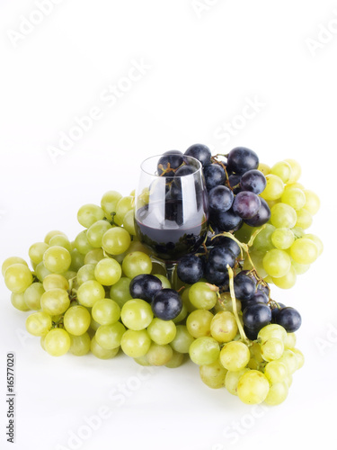 a glass of wine with grapes
