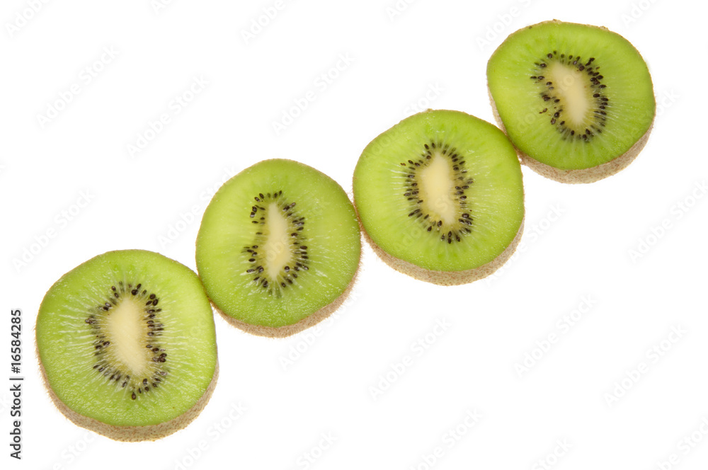 Fototapeta premium Four kiwi fruit slices lit from below