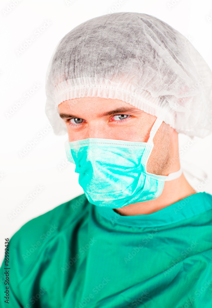 Surgeon with mask and hat on looking at the camera Surgeon with mask and hat on looking at the camera