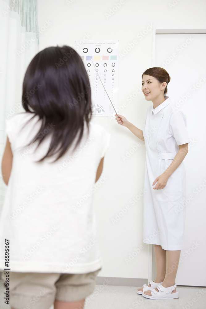 Fototapeta premium 女の子の視力検査を行う看護師