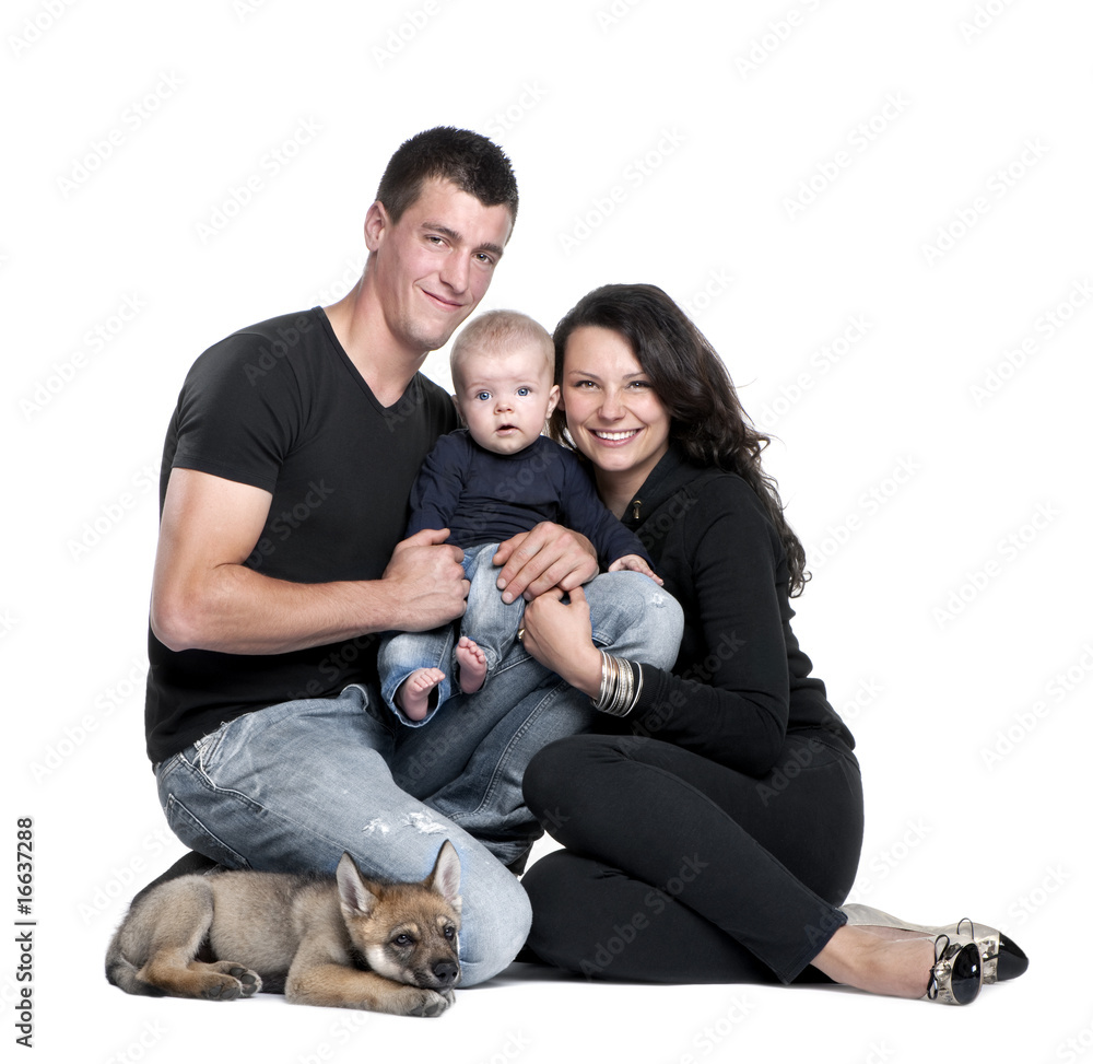 Portrait of young family with baby boy and a wolf cub Portrait of young family with baby boy and a wolf cub