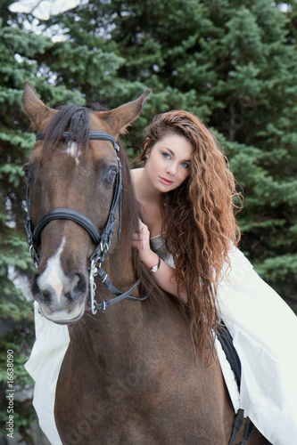Girl in a white dress on a horse