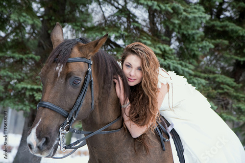 Girl in a white dress on a horse