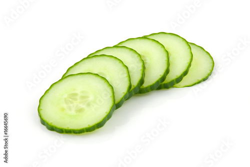 Slices of fresh cucumber over white background