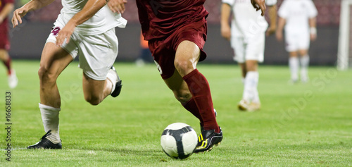 Slika na platnu Soccer players running after the ball