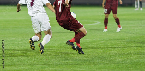 Soccer players running after the ball © Melinda Nagy