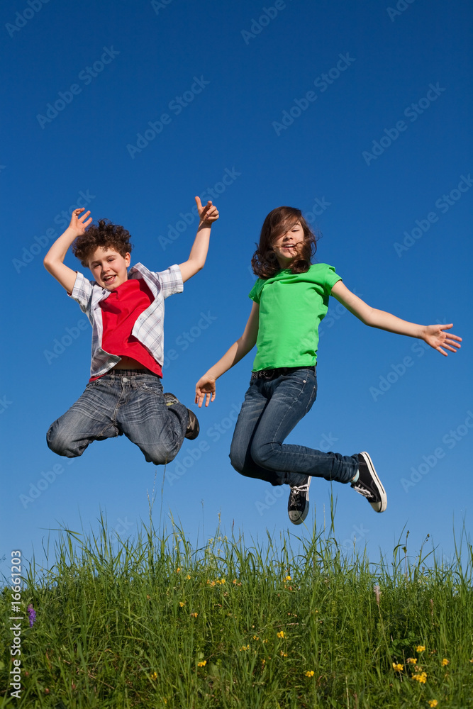 Kids running, jumping on green meadow Kids running, jumping on green meadow