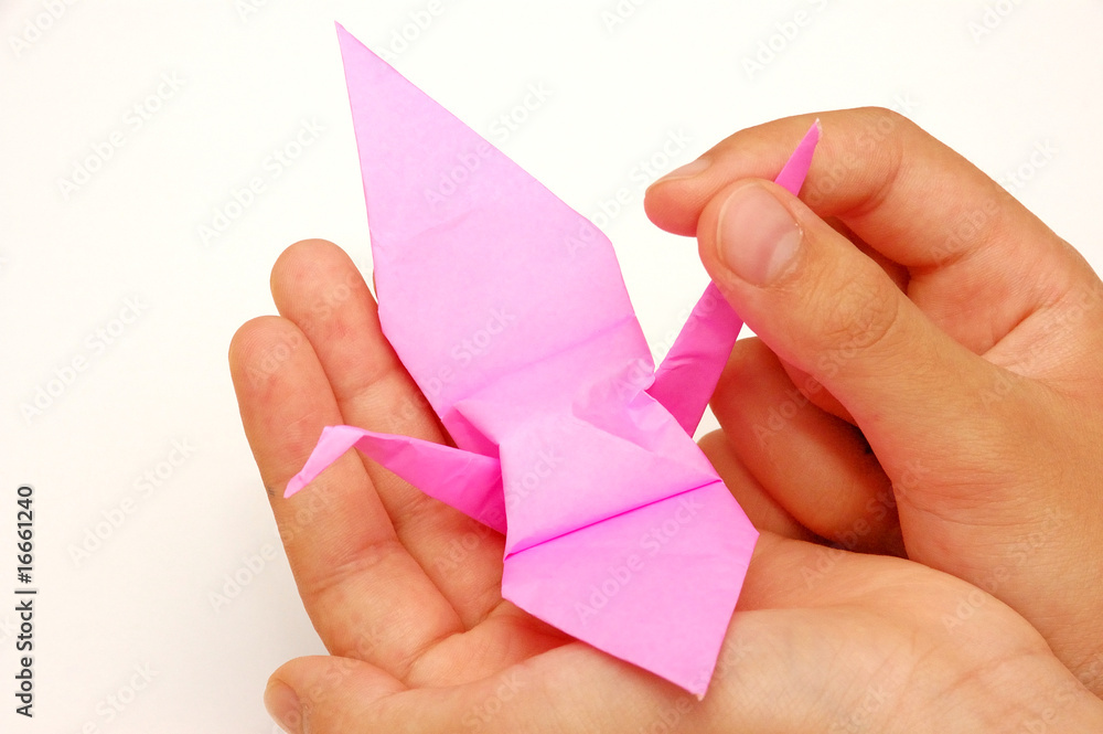 Child's Hand Holding an Origami Paper Crane Child's Hand Holding an Origami Paper Crane