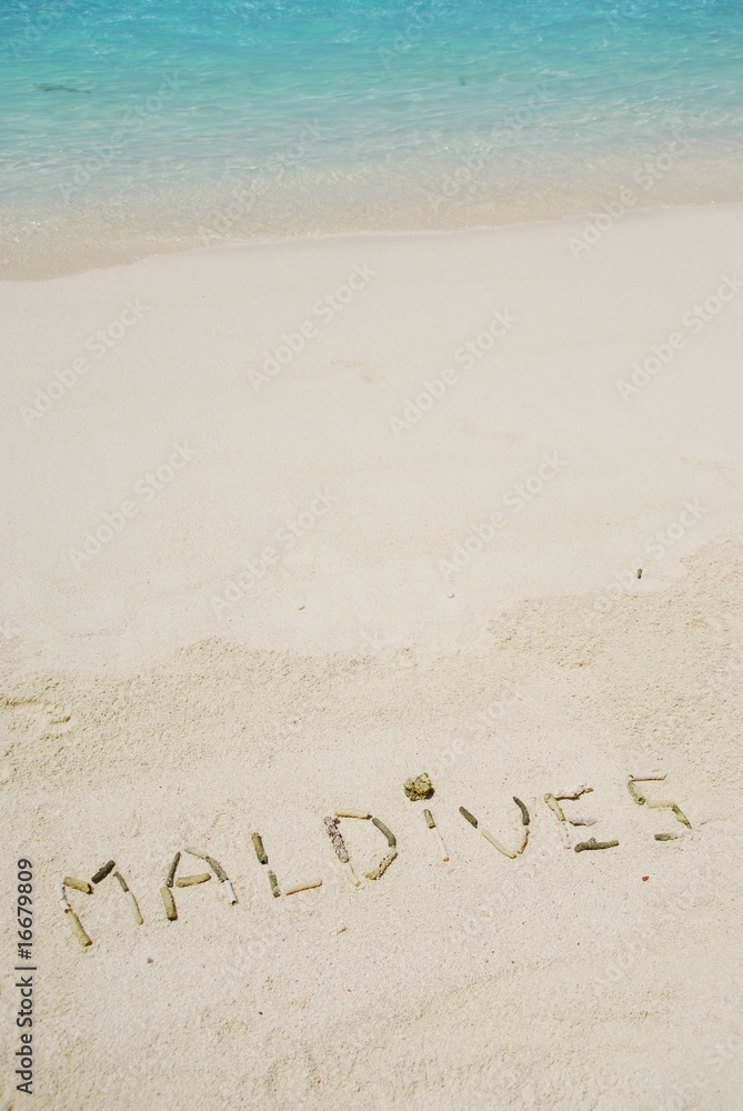 Fototapeta premium Maldives written in a sandy tropical beach