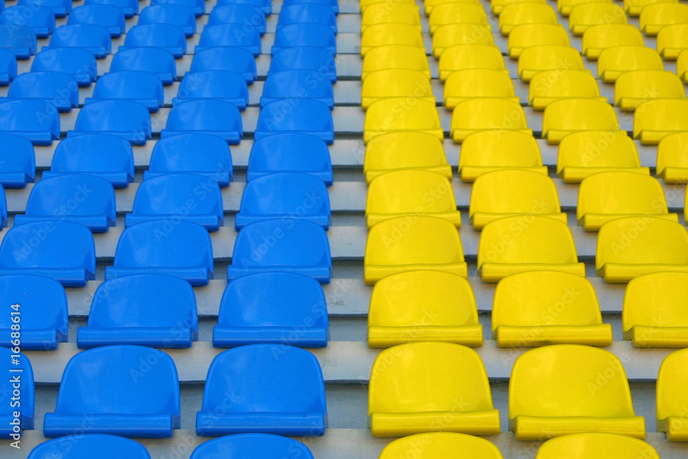 Blue and yellow empty stadium seats Blue and yellow empty stadium seats