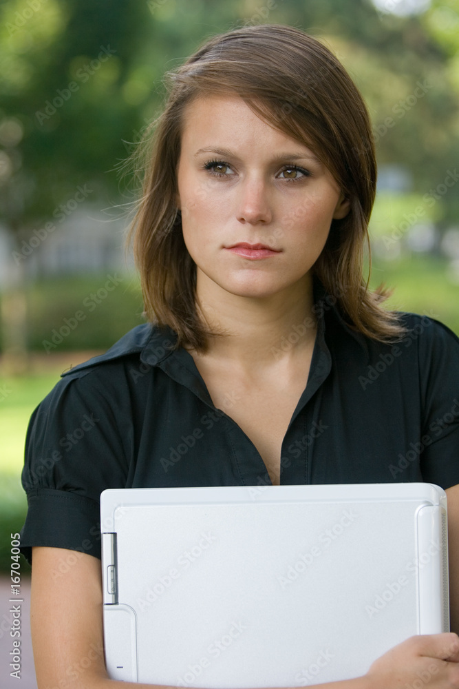 female holding laptop