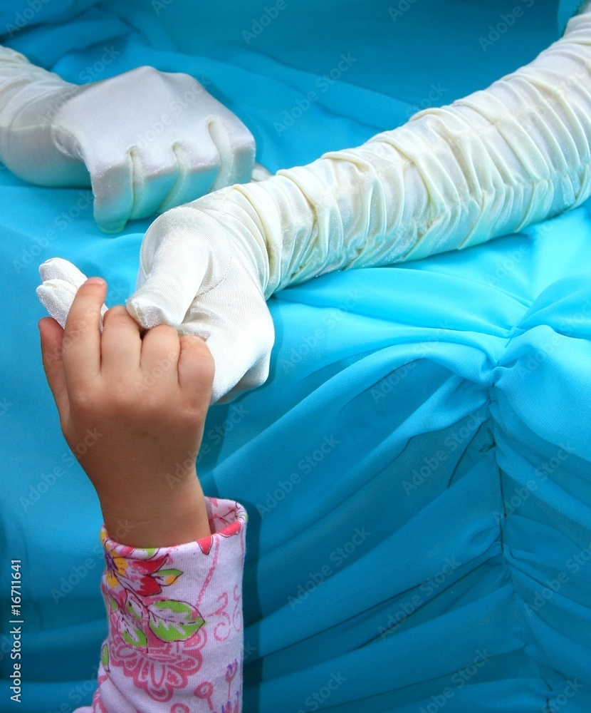 Fototapeta premium hands in silk gloves holding kids hand