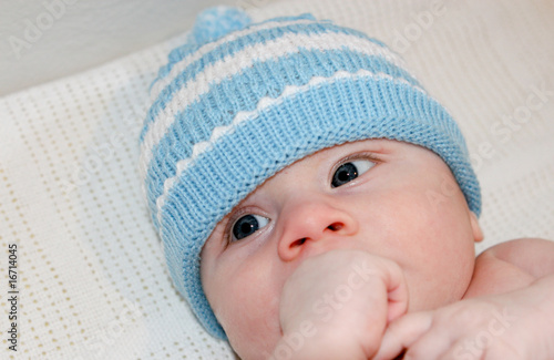 Portrait of a cute young baby in a winter hat.