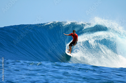 Surfer riding perfect tropical blue wave, Mentawai, Indonesia