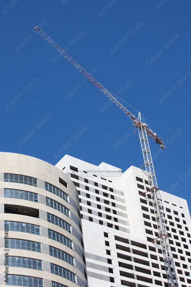 Construction site with big cranes and blue sky