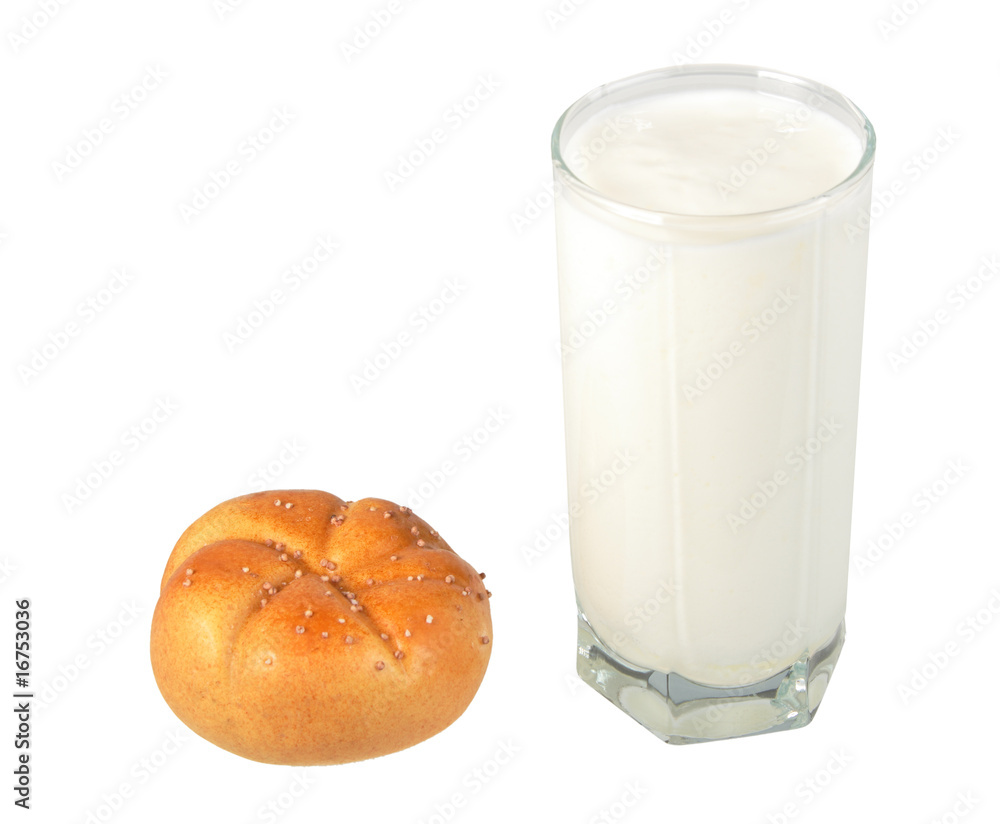 Milk in transparent glass and yellow-orange bagel. Milk in transparent glass and yellow-orange bagel.