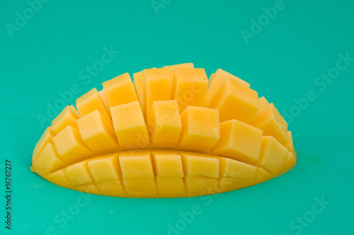 Ripe mango on a green background photo