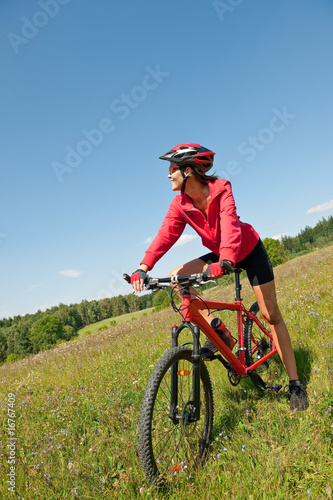 Young sportive woman on mountain bike