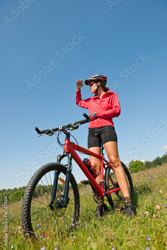 Young sportive woman on mountain bike