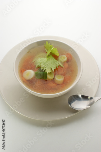 delicious vegetable soup in a white bowl with a spoon