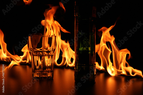 Glass and bottle on bar rack in fire