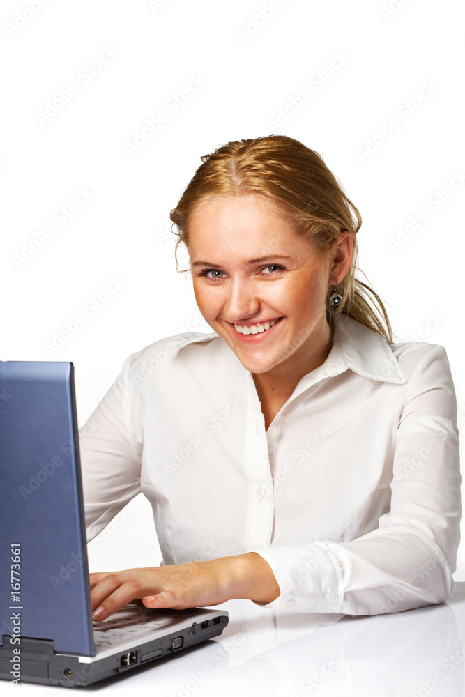 A Happy successful business woman smiling while working on lapto A Happy successful business woman smiling while working on lapto