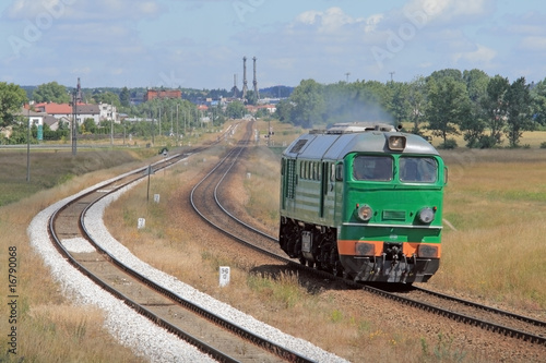 Lonely diesel locomotive passing through countryside