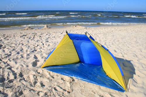 Blue-yellow tent on the beach