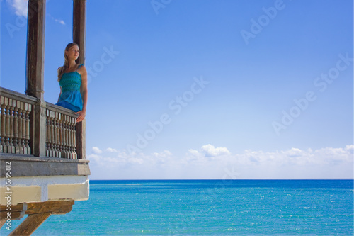Beautiful woman in paradise on a balcony